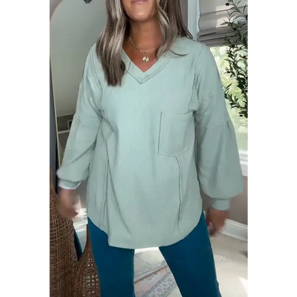 Top com decote em V malha canelada mangas balão e cor sólida